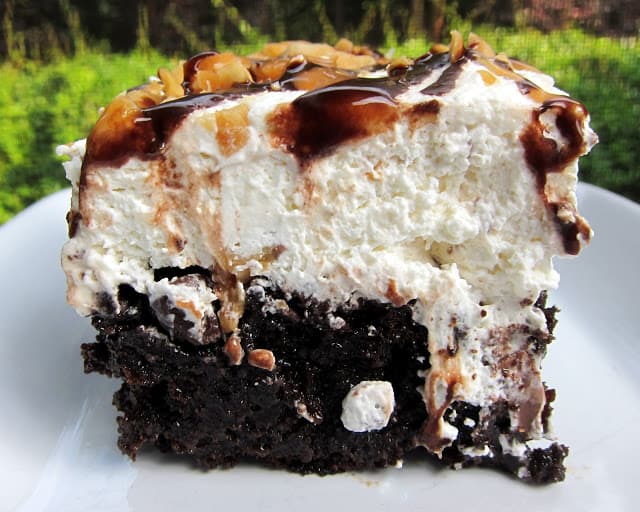 Snickers Poke Cake Recipe - chocolate cake, caramel, whipped cream, peanuts and chocolate sauce - OMG! There is NEVER any left! People go nuts over this cake!!