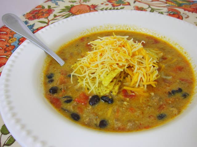 Cheesy Taco Soup - Ready in 30 minutes! Sausage/Hamburger, onion, garlic, chili powder, cumin, chicken broth, black beans, Rotel, Rotel, milk - It is hard to beat this quick soup! Reduce the calories/fat by using ground turkey. We eat this at least once a month!