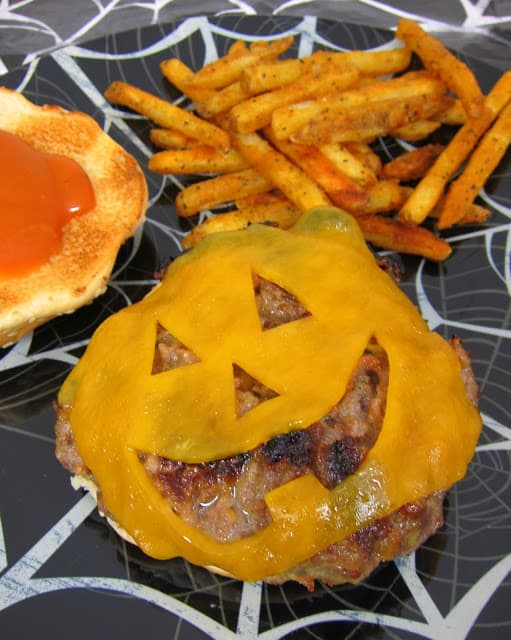 Jack-O-Lantern Cheeseburgers - fantastic homemade Ranch burgers topped with a fun Halloween cheese cut out. Cut out a jack-o-lantern face in the cheese for a festive halloween burger!