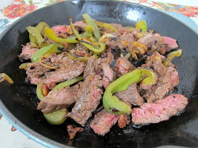 Rotel Fajitas - THE BEST fajitas! SO easy and CRAZY good! Marinate chicken or skirt steak in Rotel, beer, lemon juice, Worcestershire, garlic and pepper. Add onions and peppers to the skillet for great flavor. Our favorite Mexican recipe!