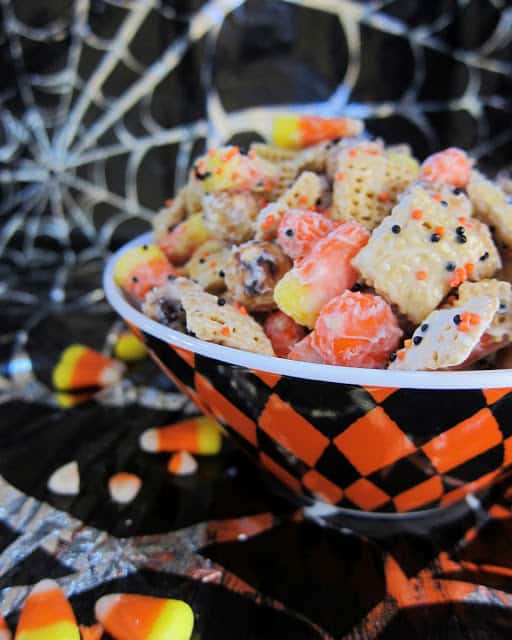Halloween Chex Mix - chocolate coated chex mix with candy corn, pretzels and chocolate. Sweet & Salty! Takes minutes to make. Great for class party treats!