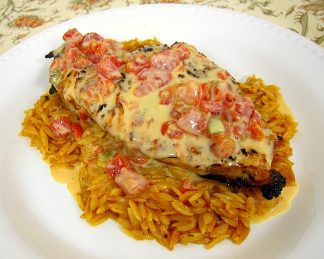 Queso Smothered Chicken - Tex-Mex grilled chicken smothered in Queso and served over southwest seasoned orzo. SO quick and easy to make.This chicken is AMAZING! I wanted to lick my plate!!! 