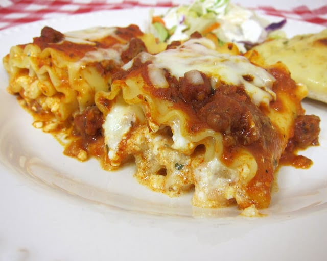 Lasagna Rolls Recipe - Lasagna noodles, topped with cheeses, rolled up  and topped with sauce and mozzarella - great make-ahead meal. Can also freeze unbaked.