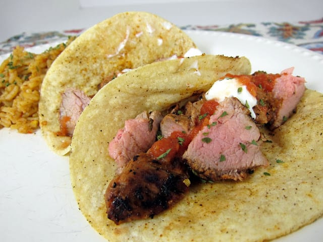 Grilled Pork Tacos Recipe - pork tenderloin marinated in lime juice, oregano, sugar, chipotle peppers, garlic and olive oil - grill to perfection, chop, serve in corn tortillas with your favorite taco toppings. SO yummy! I double the recipe for leftovers.