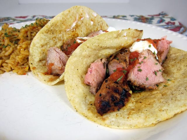 Grilled Pork Tacos Recipe - pork tenderloin marinated in lime juice, oregano, sugar, chipotle peppers, garlic and olive oil - grill to perfection, chop, serve in corn tortillas with your favorite taco toppings. SO yummy! I double the recipe for leftovers.