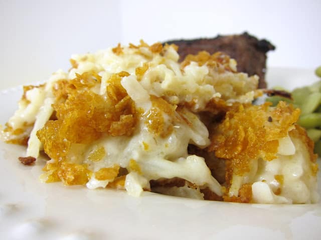 Creamy Potato Casserole - our favorite potato casserole! Frozen hash brown potatoes, chicken soup, mushroom soup, sour cream, top with crushed cornflakes. Great for a crowd/potluck. Freezes great for a quick side dish later!