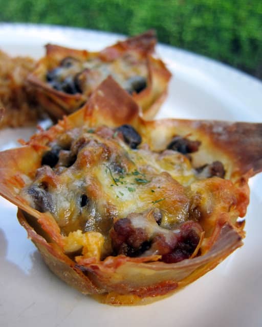 Taco Cupcakes Recipe - the original recipe! Taco meat, black beans, and cheese baked in wonton wrappers in a muffin pan. Top with your favorite taco toppings. Kids (and adults) love these! Great for lunch, dinner or parties!!