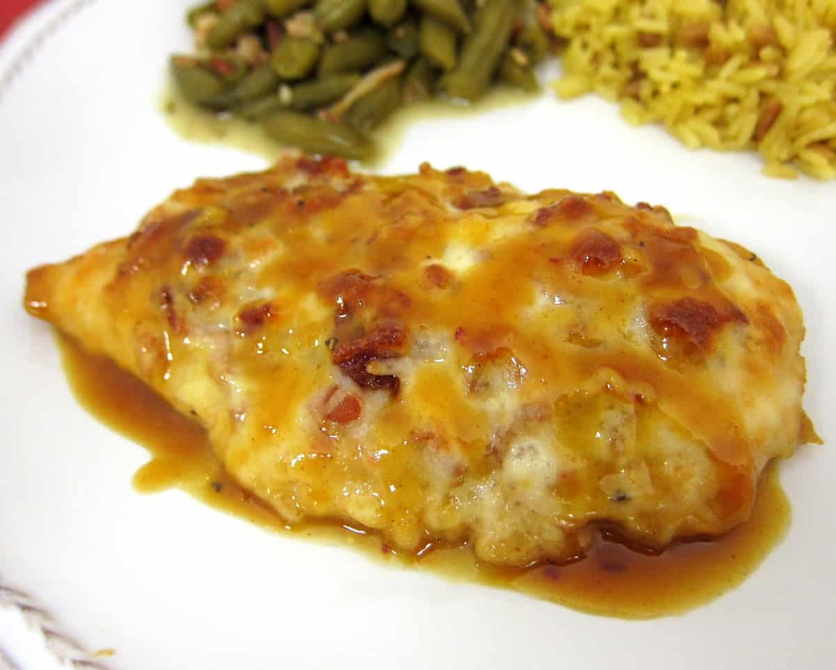 Cheesy Honey Mustard Chicken - TO DIE FOR!!! Chicken topped with honey, mustard, lemon juice, paprika, lemon pepper, bacon, Mozzarella and baked. Ready in under 30 minutes. We ate this two nights in a row. It is that good. Even picky eaters love this!