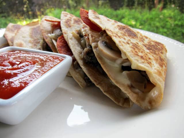 Pizzadilla Recipe - pizza quesadilla - all your favorite pizza toppings grilled in-between a tortilla. Serve with a side of warm pizza sauce - our favorite!! Great for a quick lunch or dinner.