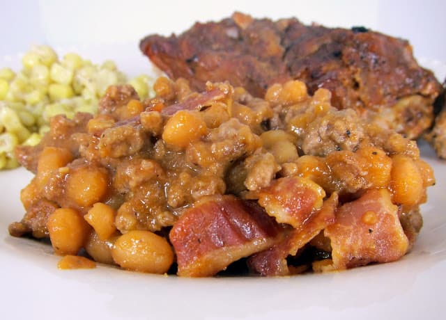 Ground Beef and Baked Bean Casserole Recipe - ground beef, pork and beans baked in a homemade bbq sauce and topped with bacon. Perfect side dish for holiday BBQs. Can make ahead and bake when ready.