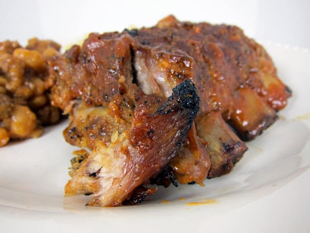 Fall Off the Bone Ribs Recipe - baby back ribs coated with a homemade BBQ rub and baked. Finish off on the grill with a homemade BBQ sauce. THE BEST! Better than any restaurant. We never order ribs out anymore. 