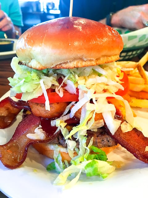 BBQ Bacon Cheeseburger at Beef O'Brady's in Birmingham, AL!! Fresh Angus covered with Sweet Baby Ray's BBQ sauce, melted American cheese, smoked bacon and two onion rings. Served with lettuce and tomato. Holy cow!