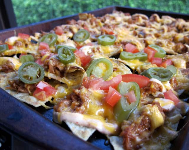 Game Day BBQ Pork Nachos Recipe - BBQ Pork, Cheese, Sour Cream, Tomatoes, Jalapeños and Tortilla Chips - Quick Recipe for a party! These are always gone in a flash!