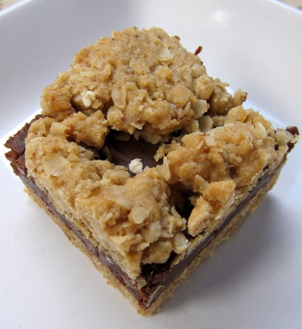 Oatmeal Fudge Bars - oatmeal almond cookie bars with a yummy fudge layer in the middle. Great make ahead dessert. Perfect potluck dessert.