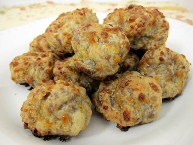 Boursin Cream Cheese Sausage Balls - tons of great flavor!  Italian sausage, boursin cheese, mozzarella, cream cheese and Bisquick. Can make ahead and freeze balls for a quick snack/appetizer later!! #sausageballs #appetizer #freezermeal