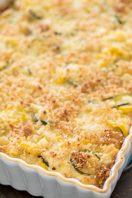 Zucchini, Squash & Corn Casserole - our favorite side dish! Zucchini, Squash, Corn, Onion, garlic, white cheddar cheese, sour cream, mayonnaise, eggs, breadcrumbs and parmesan cheese. Seriously THE BEST!!! Great make ahead side dish. Perfect for all your potlucks, cookouts and holiday meals! #casserole #zucchini #squash #corn #sidedish #freezermeal