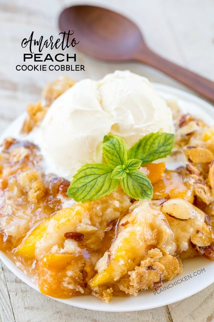 Amaretto Peach Cookie Cobbler - heaven in a pan! CRAZY good!!! Super easy to make and a real crowd pleaser. Peach pie filling, peaches, amaretto, sugar cookie mix, sliced almonds and butter. Ready to eat in 30 minutes! There are never any leftovers when I take this to a potluck. Such a wonderful and easy dessert recipe!