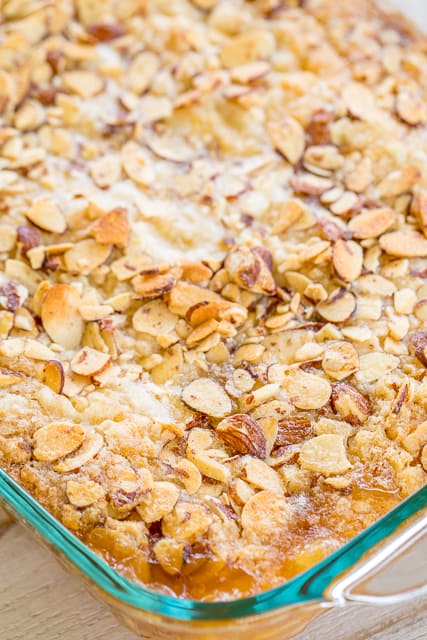 Amaretto Peach Cookie Cobbler - heaven in a pan! CRAZY good!!! Super easy to make and a real crowd pleaser. Peach pie filling, peaches, amaretto, sugar cookie mix, sliced almonds and butter. Ready to eat in 30 minutes! There are never any leftovers when I take this to a potluck. Such a wonderful and easy dessert recipe!