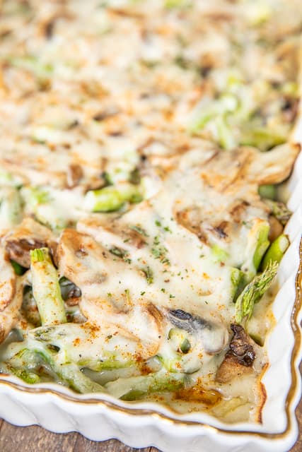 baked cheesy asparagus and mushrooms in casserole dish