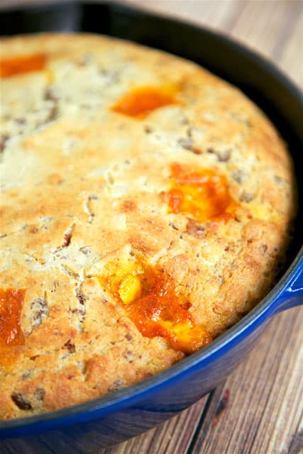 Bacon Cheeseburger Cornbread - comfort food at its best! Homemade Southern buttermilk cornbread loaded with hamburger meat, bacon and cheddar cheese. The chunks of ooey gooey melted cheese are the star of this dish! Serve with a salad for a quick and easy weeknight meal!! Also makes a great dish for a potluck.