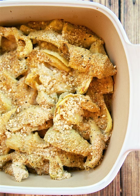 Easy Baked Artichokes - SO good and SOOO easy!!! All the flavors of stuffed artichokes without all the work. Canned artichokes, olive oil, garlic, bread crumbs and parmesan cheese. Only takes a minute to make! Great with steak, chicken pork and even pasta! LOVE quick and easy side dish recipes!