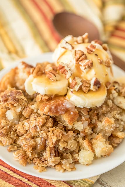 Banana Bread Cobbler - this is amazing!! SOOO much better than regular banana bread. The streusel topping makes this yummy dessert!! Self-rising flour, sugar, milk, butter, bananas, brown sugar, oatmeal and pecans. Top with vanilla ice cream and caramel sauce! This is lick-the-plate delicious!!! #bananabread #cobbler #dessert #dessertrecipe