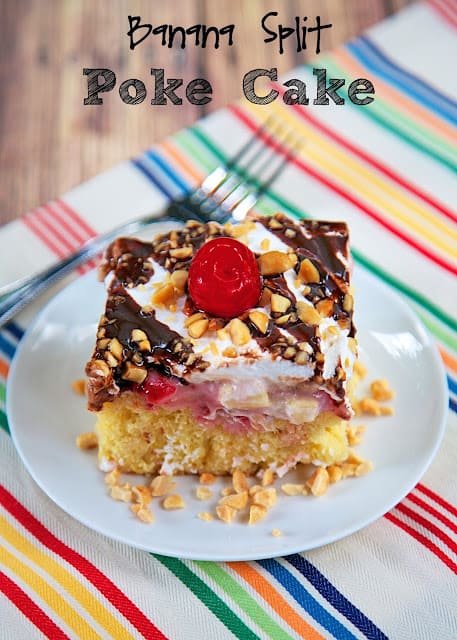 Banana Split Poke Cake Recipe - all the flavors of a banana split in cake form! Yellow cake with pineapple. strawberry ice cream topping, bananas, Cool Whip, chocolate syrup, peanuts and cherries. Can be made several days in advance. Great for a potluck!