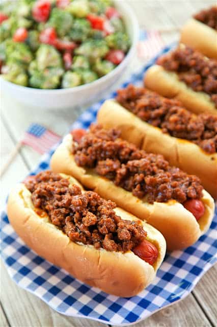 BBQ Beef Hot Dogs - only 4 ingredients! Hamburger, BBQ sauce, hot dogs and buns. SO easy and SO delicious! Top with cheese and fried onions if desired. The whole family loved these. Great for cookouts and tailgates!