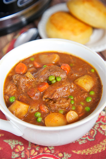 Slow Cooker Beef Stew - beef, potatoes, carrots, green peas, tomatoes, celery, chili powder, brown gravy mix, beef broth. Comfort food at its best! So easy and SO good. Everyone gobbled this up - even the kids!! Serve with some biscuits or cornbread for a complete meal!