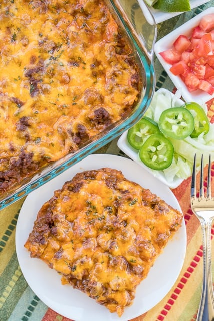 Beef Tamale Casserole - sweet cornbread crust topped with seasoned beef, enchilada sauce and cheese. A real crowd pleaser! Everyone always cleans their plate!! Such an easy Mexican casserole recipe!!! Jiffy Mix, eggs, milk, creamed corn, hamburger meat, taco seasoning, enchilada sauce and cheddar cheese. Make it tonight! You won't be disappointed!