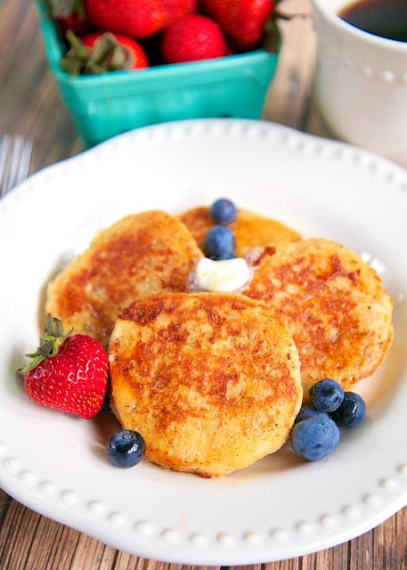 Biscuit French Toast Recipe - day old biscuits soaked in eggs, milk, and cinnamon, then grilled. Serve with syrup and fresh berries for a delicious breakfast! Great way to use up leftover biscuits!!
