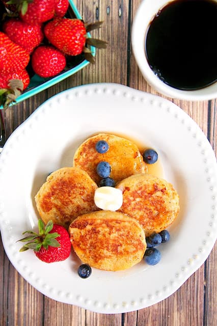 Biscuit French Toast Recipe - day old biscuits soaked in eggs, milk, and cinnamon, then grilled. Serve with syrup and fresh berries for a delicious breakfast! Great way to use up leftover biscuits!!
