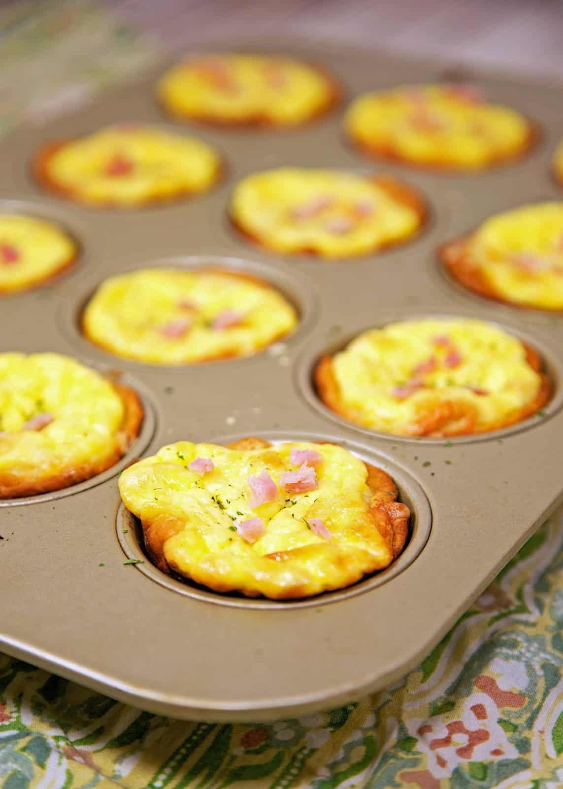 Ham & Cheese Biscuit Quiches Recipe - ham and cheese quiche baked in a biscuit crust. Great way to use up leftover holiday ham! Freeze leftovers for a quick meal later!!