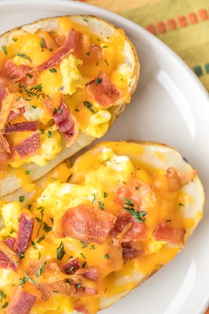 Breakfast Potato Skins - potato skins loaded with eggs, bacon and cheddar cheese. Can make the potatoes ahead of time and finish off in the morning for a quick breakfast. Everyone LOVES these! Can customize with your favorite toppings - sour cream, salsa, green onions. The possibilities are endless!