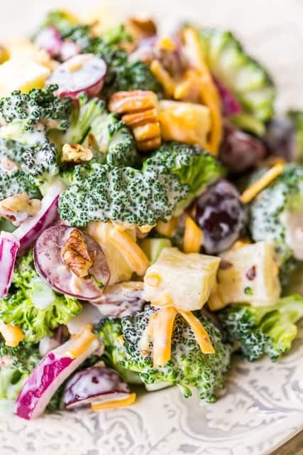 Broccoli Pineapple Salad - so simple and SOOO good!! Seriously delicious!! Fresh broccoli, cheddar cheese, red onion, red grapes, fresh pineapple, pecans, bacon, mayonnaise, cider vinegar and sugar. Great for spring/summer cookouts, potlucks, camping and Easter side dish! We ate this for lunch and dinner the same day. Can make ahead and refrigerate for several days. Such a quick and easy fruit and vegetable side dish recipe!