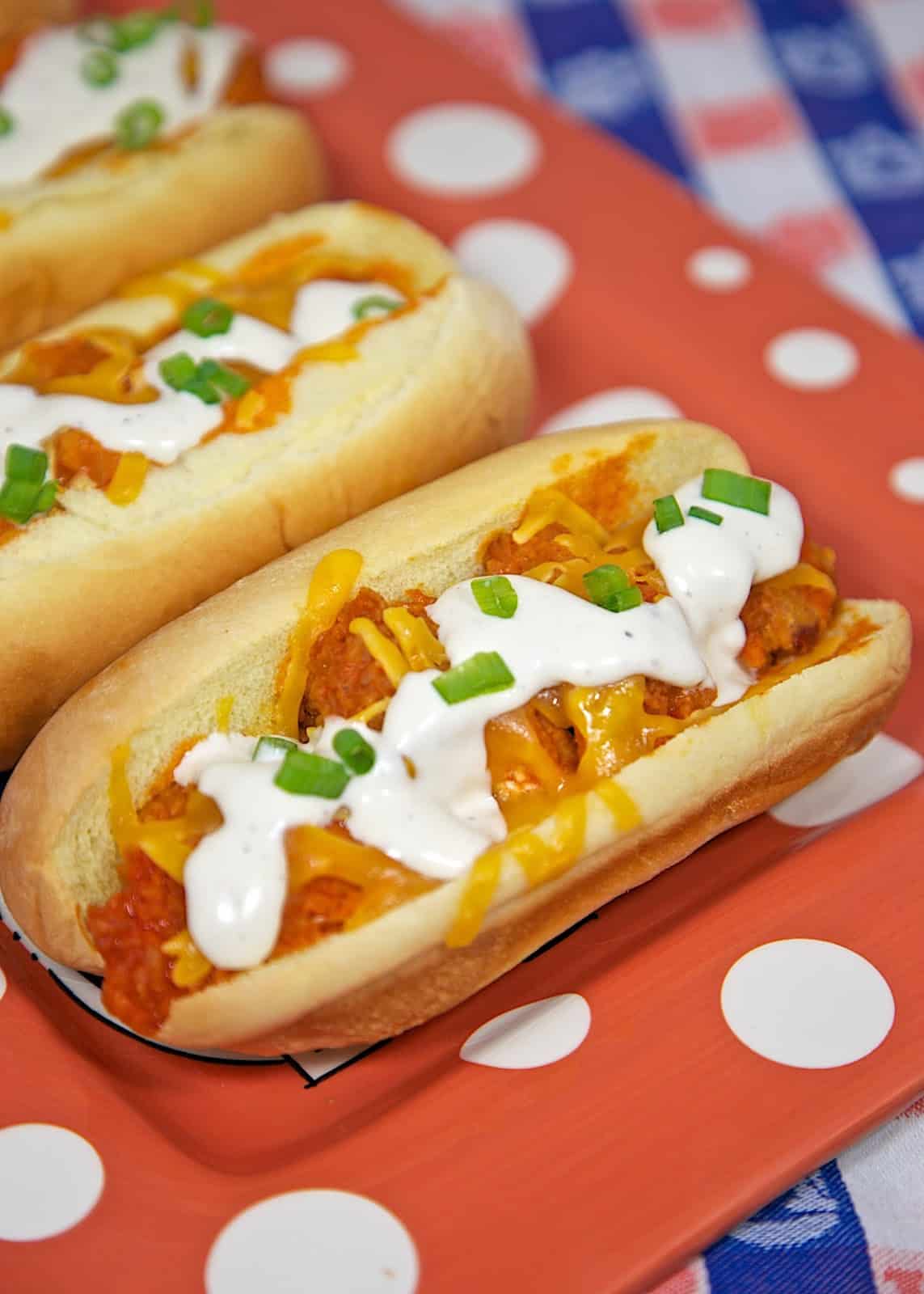 Buffalo Chicken Bird Dogs Recipe - chicken tenders, buffalo sauce, cheese and Ranch served in hot dog buns. Our favorite way to eat chicken tenders!