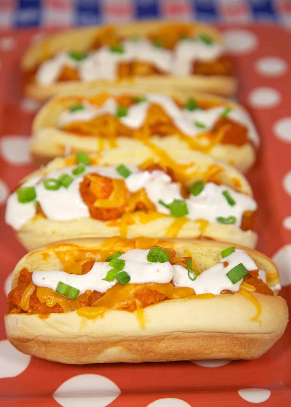 Buffalo Chicken Bird Dogs Recipe - chicken tenders, buffalo sauce, cheese and Ranch served in hot dog buns. Our favorite way to eat chicken tenders!