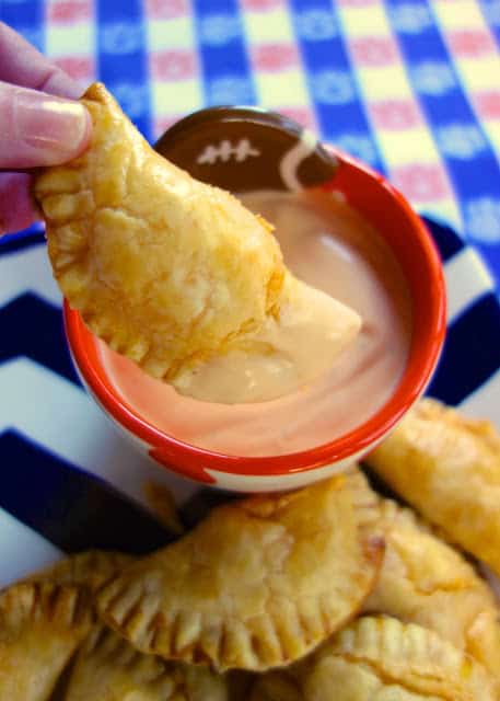 Buffalo Chicken Empanadas - buffalo chicken and cheddar baked in pie crusts - dip in some spicy ranch! These are SOOOO good!! They were the first thing to go at the party. Everyone raved about them!!