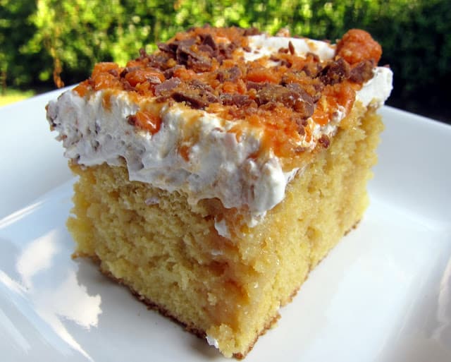 Butterfinger Poke Cake - yellow cake, caramel, sweetened condensed milk, crushed Butterfingers and cool whip. Great cake recipe for a potluck! Everyone goes crazy over this cake!! There is never any left.