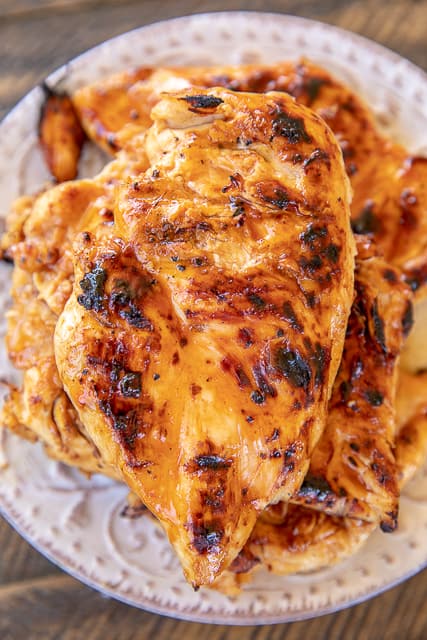 Buttermilk Hot Sauce Brined Chicken - seriously the most tender and juicy chicken we've ever made!!! Chicken marinaded overnight in buttermilk, water, salt, pepper, garlic, lime, brown sugar and hot sauce. Brush the chicken with some BBQ sauce before taking off the grill. We LOVED this chicken! We always double the recipe and never have leftovers! YUM! #chicken #grill #grilledchicken #marinade