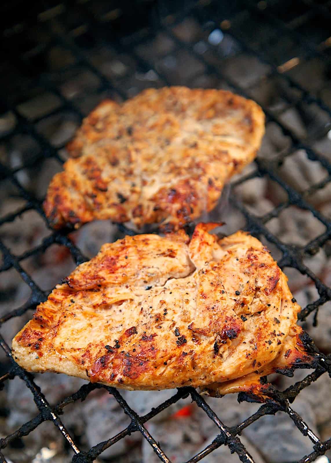 Cajun Caesar Grilled Chicken Recipe - 3 ingredient marinade! Caesar dressing, cajun seasoning and lemon juice. SO simple and super delicious! Whisk up marinade in the morning and let the chicken hang out in the fridge all day. Grill up for a quick and delicious dinner.