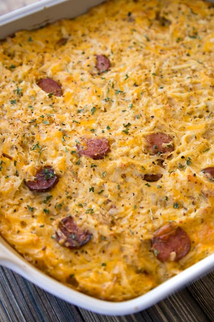 Cajun Hash Brown Casserole - cheesy hash brown casserole loaded with chicken and smoked sausage. Seriously DELICIOUS! We ate this three days in a row! OMG! Chicken, smoked sausage, cajun seasoning, cheddar cheese, hash browns, cream of chicken soup and sour cream. This is a family favorite! Makes a great freezer meal!