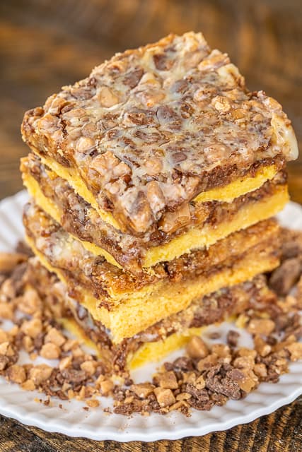 Cake Mix Toffee Bars - only 5 ingredients!! Cake mix, eggs, butter, toffee bits and sweetened condensed milk. I took these to a party and they were gone in minutes! I always double the recipe now because everyone goes crazy over this easy dessert!! These are best if you make them the day before and refrigerate overnight. Great for parties, tailgating and your holiday cookie tray. YUM! #dessert #toffee #cakemix