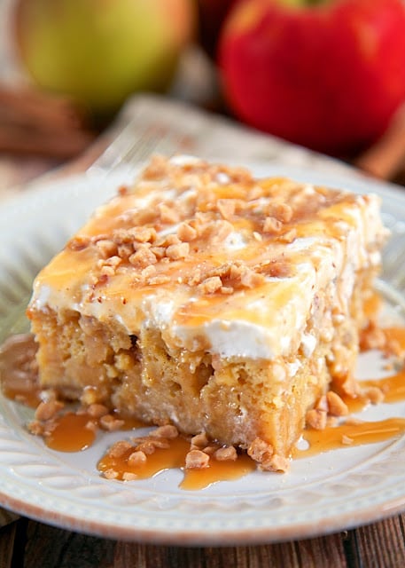 Caramel Apple Pie Poke Cake Recipe - apple cake soaked in caramel sauce topped with cool whip and toffee bits - AMAZING! Can make ahead of time and refrigerate. It gets better as it sits in the fridge. Super delicious cake!