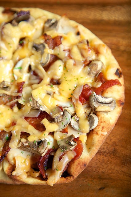 Chicken, Bacon & Smoked Gouda Flatbread Recipe - great way to use up leftover chicken. We sliced up the leftover chicken, added some bacon, mushrooms, smoked gouda and a drizzle of honey. AMAZING and super quick!