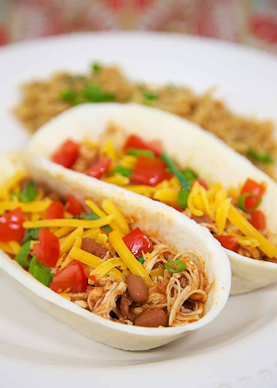 Slow Cooker Chicken Chili Tacos - only 3 ingredients! Great for tacos, topping a salad, or nachos. Makes a ton! Freeze leftovers for later. Everyone loves this easy Slow Cooker Mexican Chicken recipe!