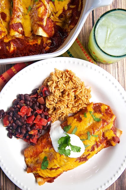 Fire-Roasted Chicken Enchiladas - chicken, cheese and corn rolled up in tortillas and topped with a quick homemade enchilada sauce - OMG! SO good! My new go-to enchilada sauce recipe! You will never, ever buy the canned stuff again! Recipe from the new Express Lane Cooking Cookbook.