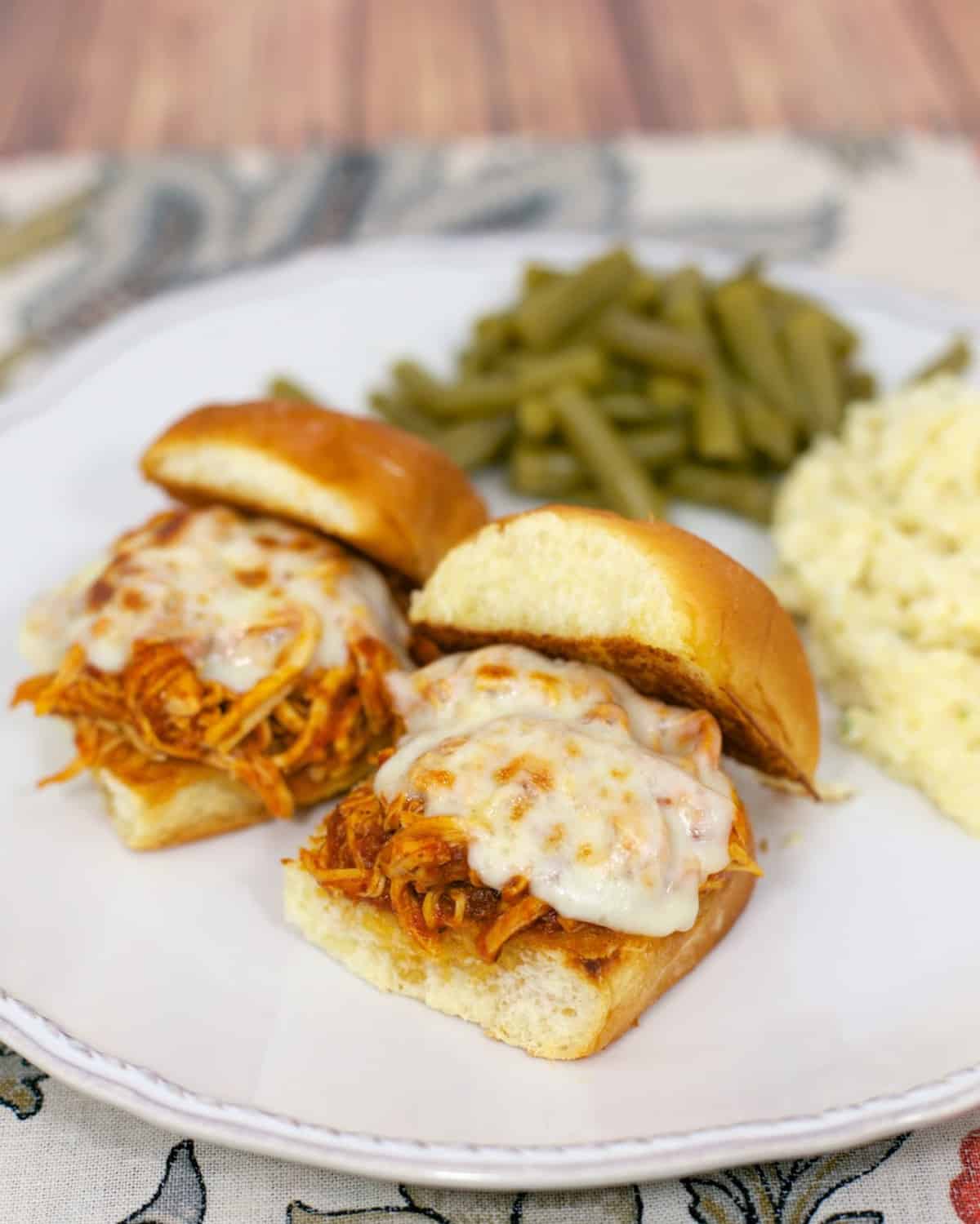 Slow Cooker Chicken Parmesan Sliders - only 3 ingredients for the chicken! Chicken, spaghetti sauce, garlic, mozzarella cheese and buns. Great for an easy weeknight meal or tailgating. Everyone cleaned their plate!!