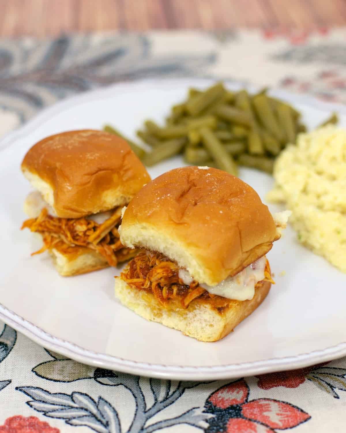 Slow Cooker Chicken Parmesan Sliders - only 3 ingredients for the chicken! Chicken, spaghetti sauce, garlic, mozzarella cheese and buns. Great for an easy weeknight meal or tailgating. Everyone cleaned their plate!!