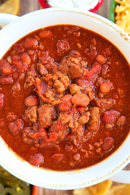 Slow Cooker Ranch Chili - THE ULTIMATE chili recipe!! Ground beef, stew meat, diced tomatoes, Rotel tomatoes, chili beans, beef broth, tomato paste, chili powder, cumin, garlic and Ranch dressing mix. This has all the best from all of my chili recipes. It is the BEST chili recipe! Great for a crowd! Serve with some cornbread for a quick and easy meal!
